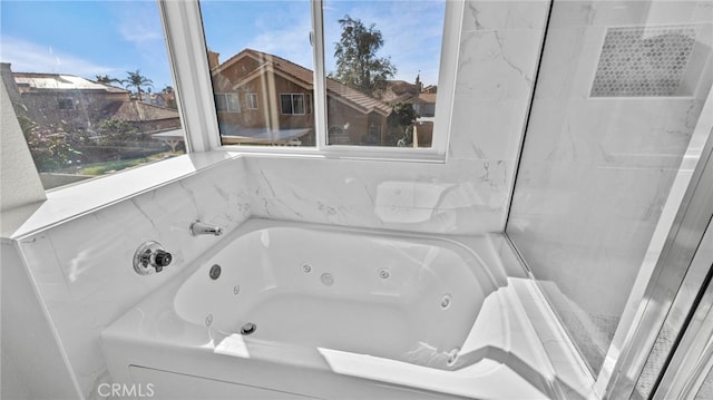 bathroom with a tub to relax in