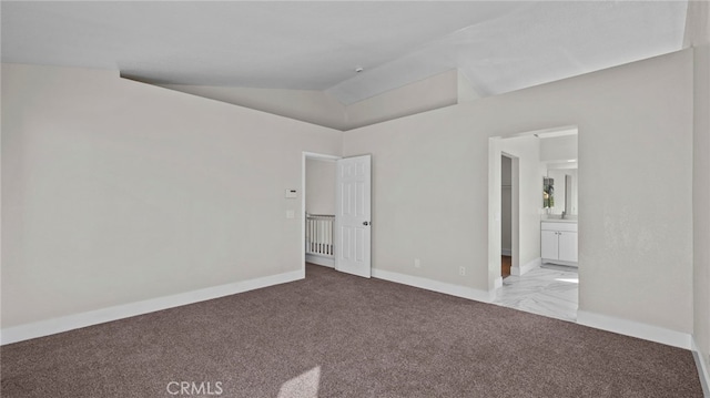 empty room featuring lofted ceiling and light carpet