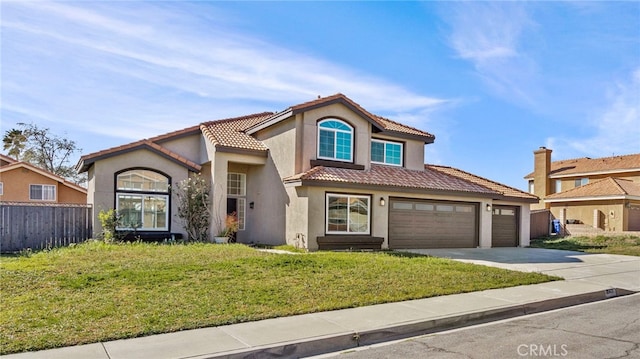 mediterranean / spanish-style house featuring a garage and a front yard