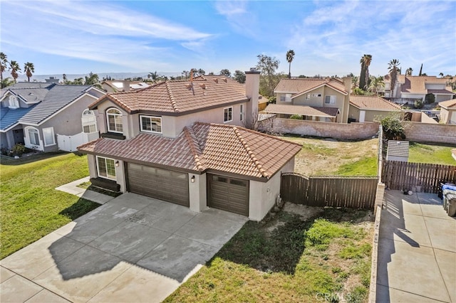 mediterranean / spanish house with a garage, fence, a tiled roof, a residential view, and stucco siding