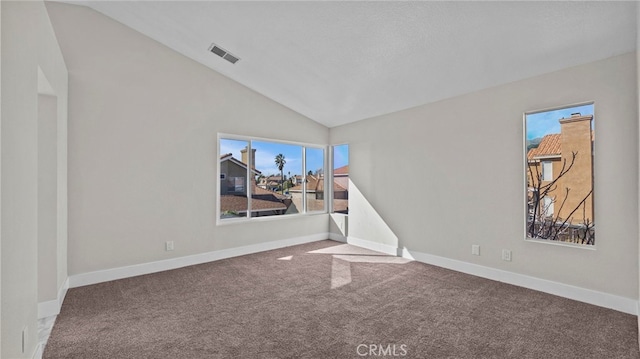 spare room featuring lofted ceiling, carpet floors, visible vents, and baseboards