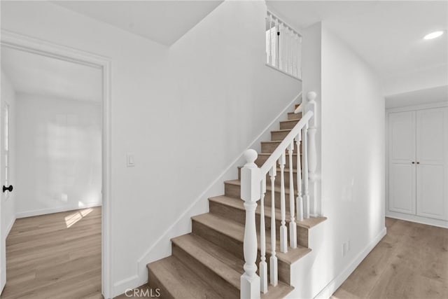 stairway featuring hardwood / wood-style flooring