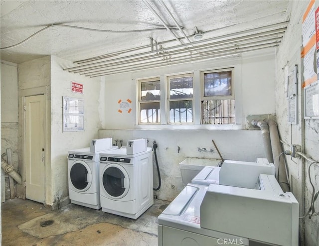 laundry area featuring sink and washer and clothes dryer