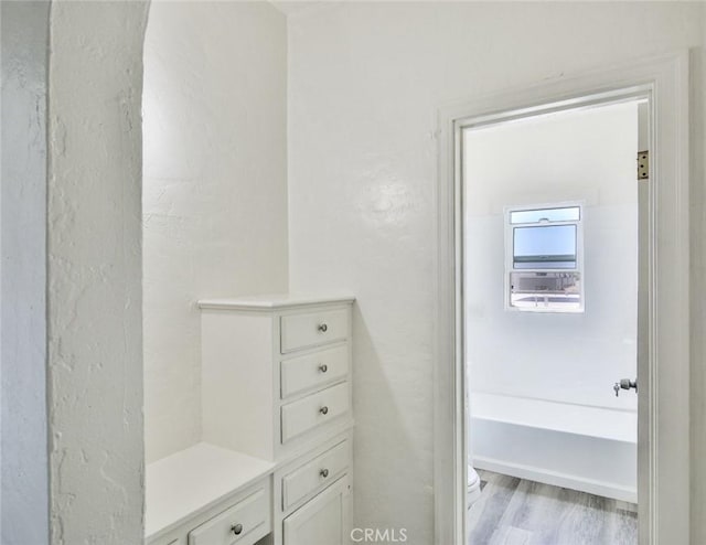 bathroom with hardwood / wood-style flooring and toilet