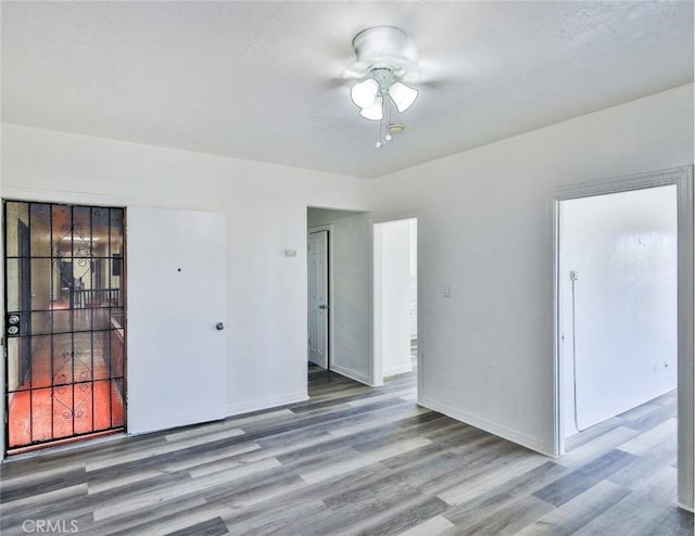 empty room featuring ceiling fan and light hardwood / wood-style flooring