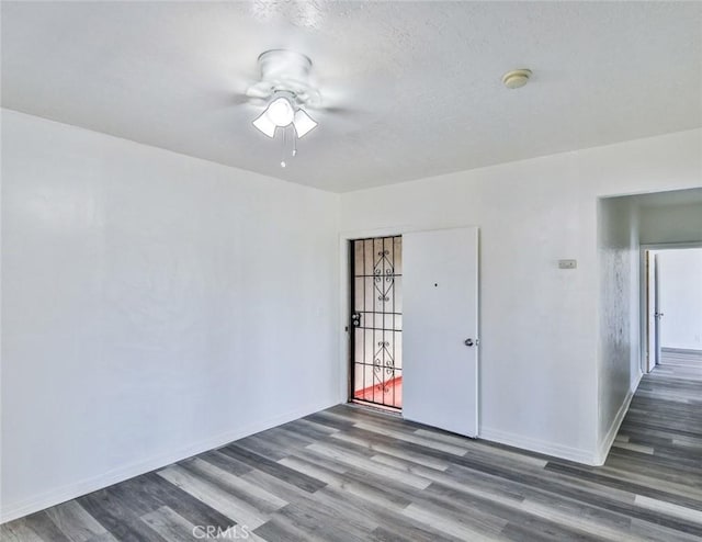 unfurnished room featuring ceiling fan and hardwood / wood-style floors