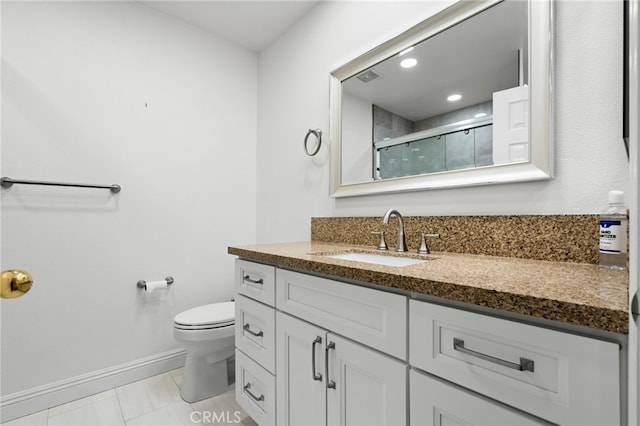 bathroom featuring vanity, tile patterned floors, toilet, and walk in shower