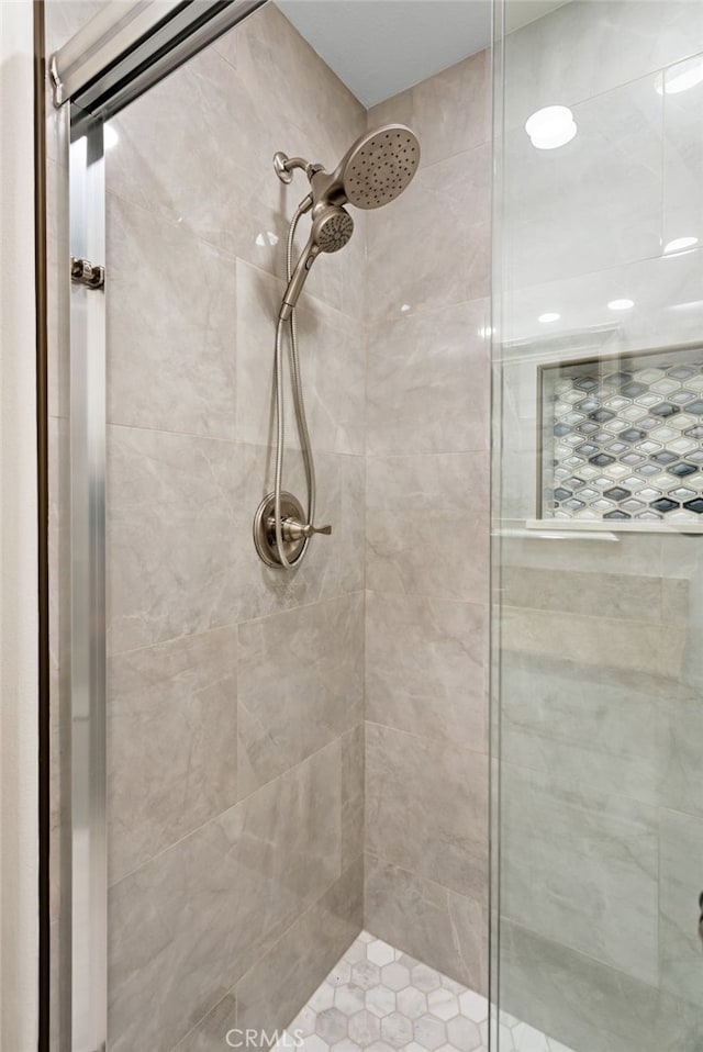 bathroom with a shower with door