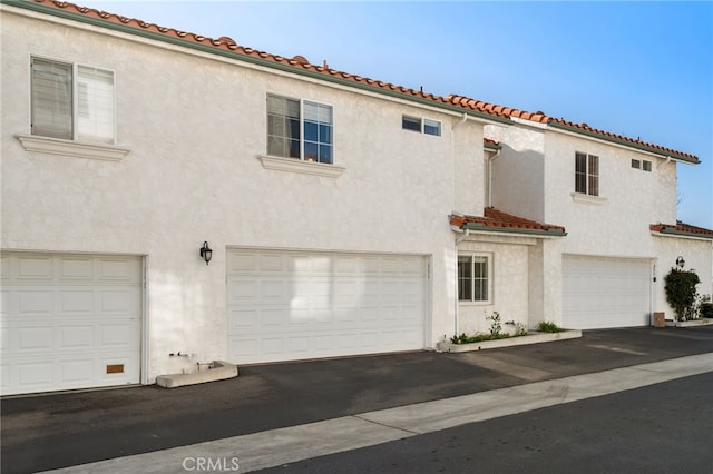 mediterranean / spanish-style home with a garage