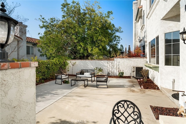 view of patio / terrace featuring an outdoor living space and central AC