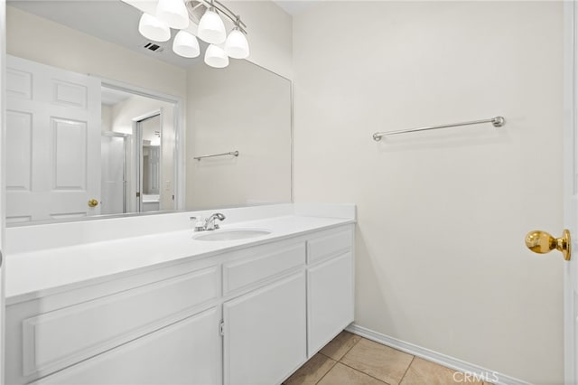 bathroom with vanity, a notable chandelier, and tile patterned floors