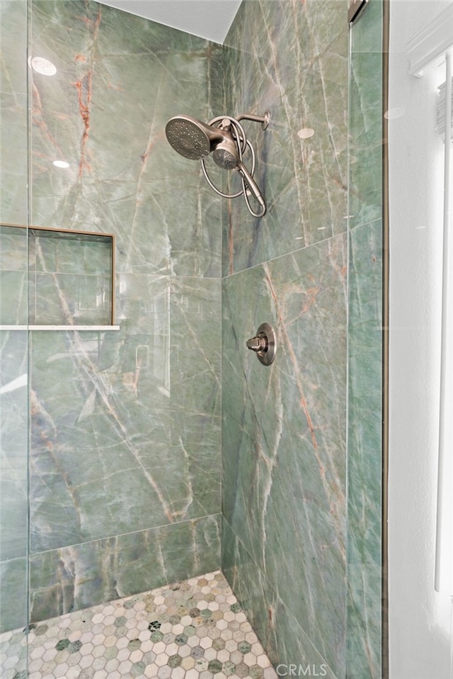 bathroom with a tile shower