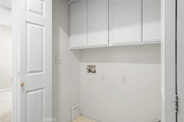 washroom with cabinets and hookup for a washing machine