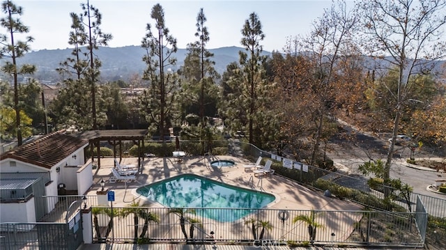 view of swimming pool featuring a mountain view and a patio