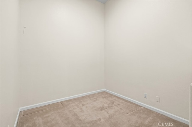 spare room with light colored carpet