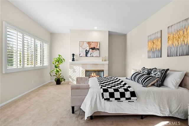 carpeted bedroom featuring a tile fireplace