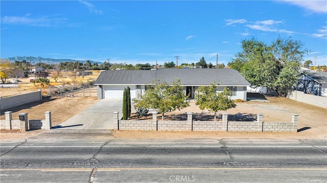 view of front of property featuring a mountain view and a garage