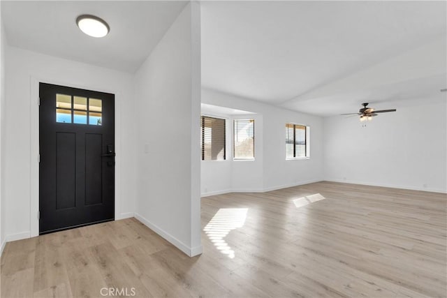 foyer with ceiling fan, light hardwood / wood-style floors, and lofted ceiling