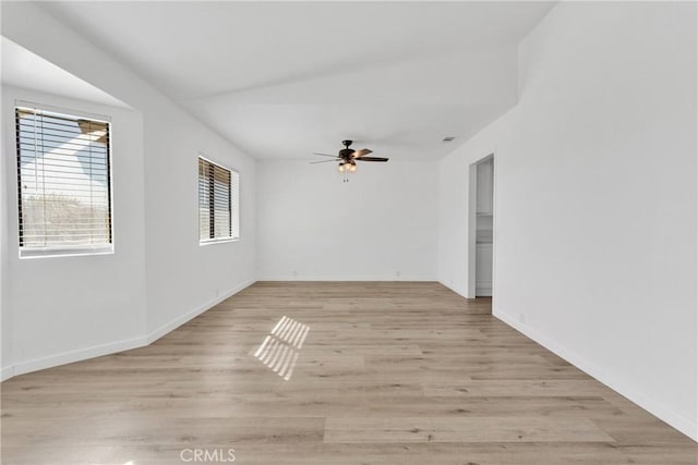 empty room with ceiling fan and light wood-type flooring