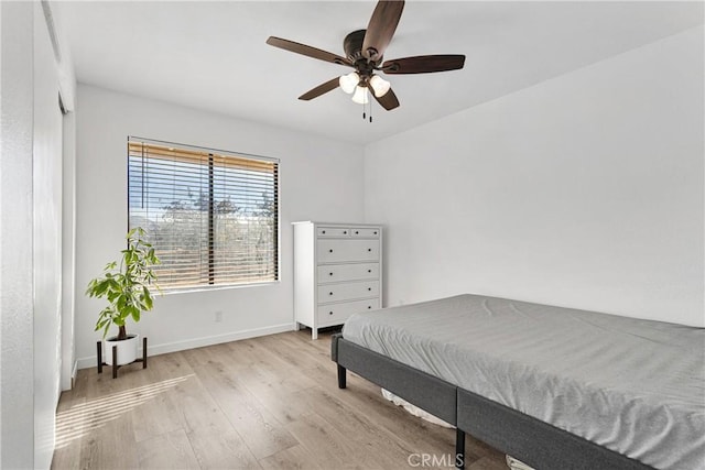 bedroom featuring light wood-type flooring and ceiling fan