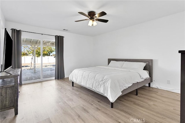 bedroom with light wood-type flooring, ceiling fan, and access to outside