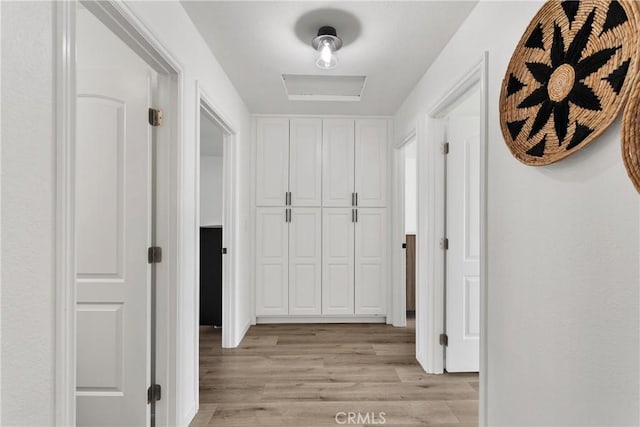 corridor with light hardwood / wood-style floors