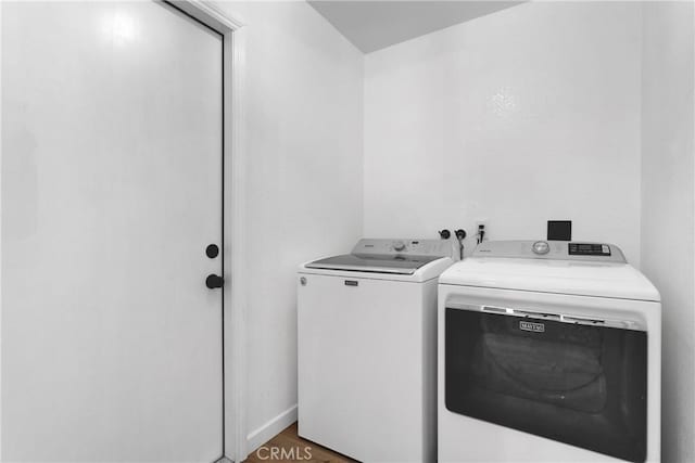 laundry area with hardwood / wood-style flooring and independent washer and dryer