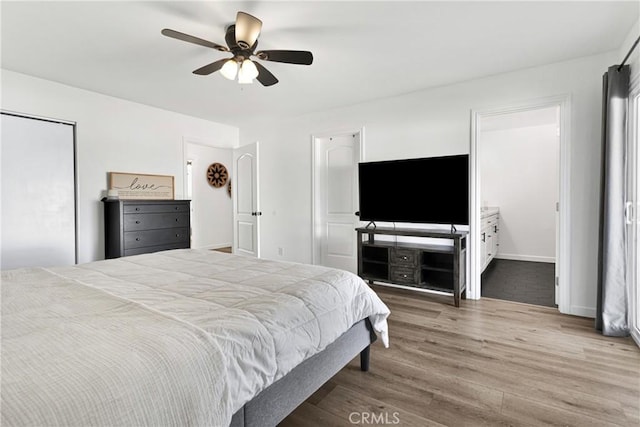 bedroom featuring hardwood / wood-style floors, connected bathroom, and ceiling fan