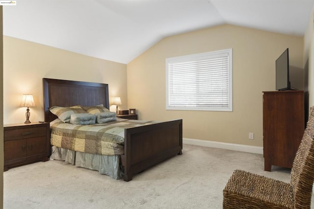 bedroom with light carpet and lofted ceiling