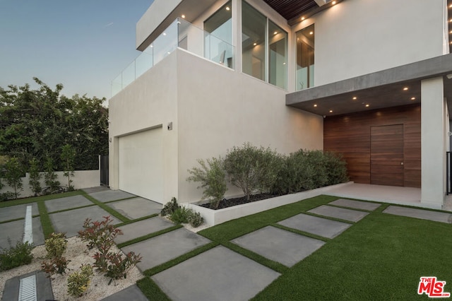 property exterior at dusk featuring a garage