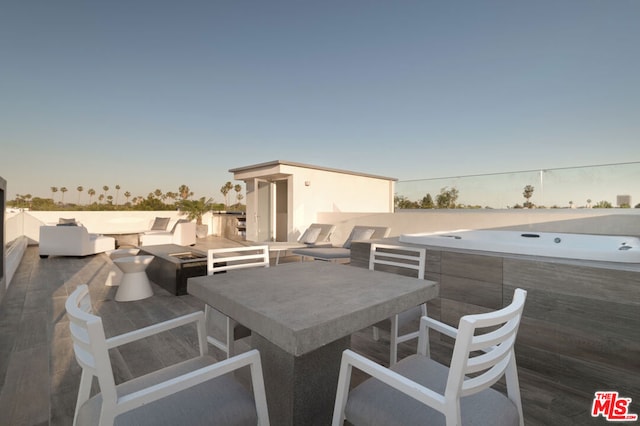 patio terrace at dusk featuring an outdoor fire pit