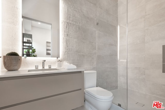 bathroom featuring vanity, toilet, and walk in shower