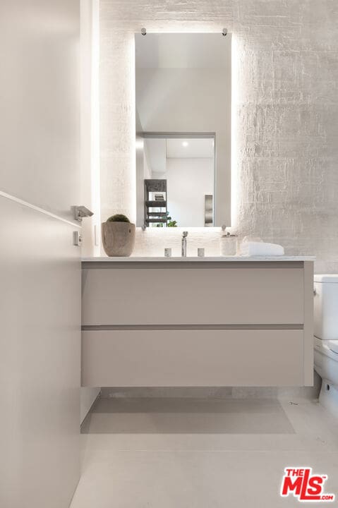 bathroom featuring toilet and vanity