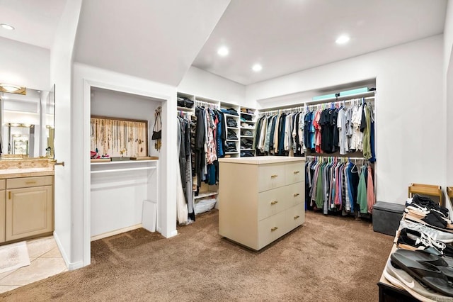 spacious closet featuring light colored carpet