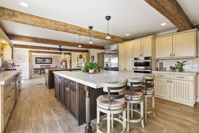 kitchen with pendant lighting, a large island, stainless steel appliances, decorative backsplash, and beamed ceiling