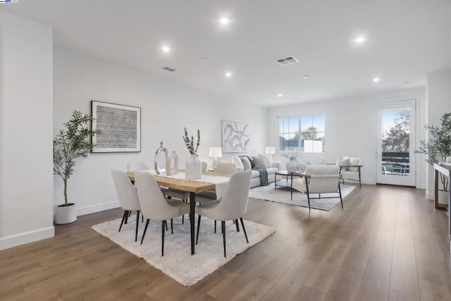 dining area with dark hardwood / wood-style flooring