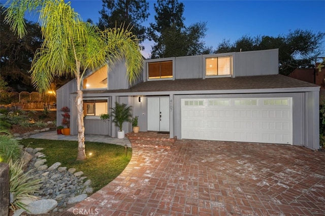 view of front of property featuring a garage and decorative driveway