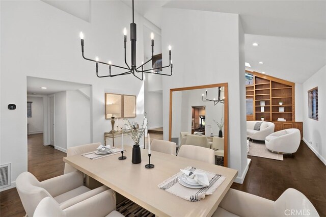 dining space with hardwood / wood-style flooring, high vaulted ceiling, and built in shelves