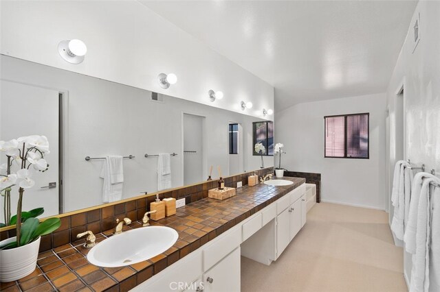 bathroom with tasteful backsplash and vanity