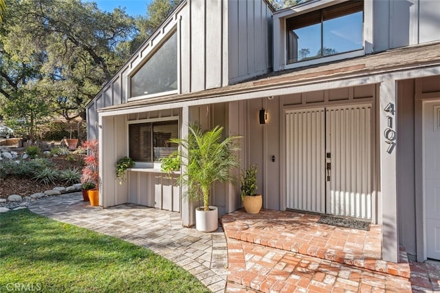 doorway to property featuring board and batten siding