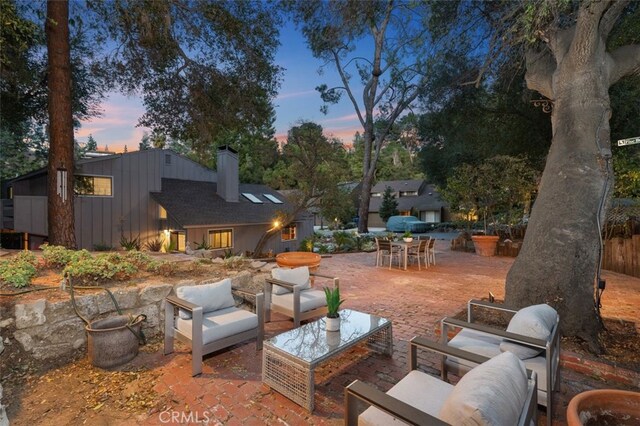 patio terrace at dusk featuring outdoor lounge area