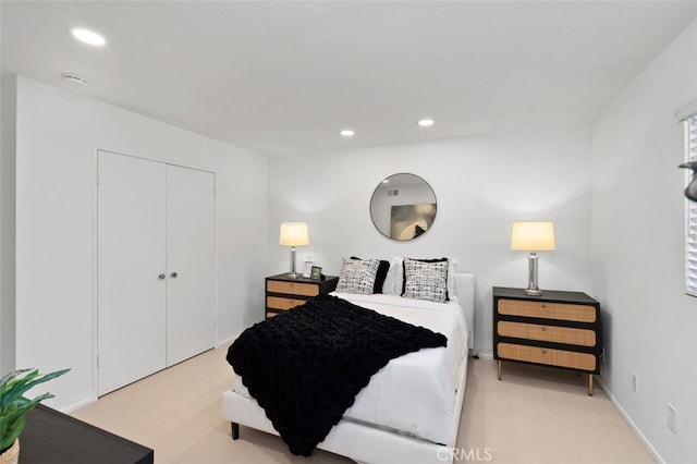 bedroom featuring recessed lighting, a closet, and light carpet