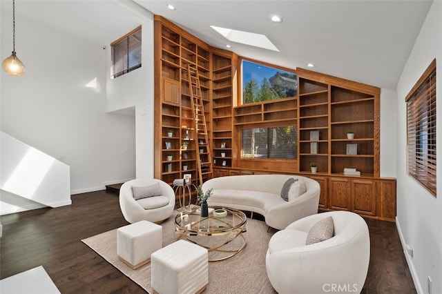 living area with high vaulted ceiling, recessed lighting, a skylight, wood finished floors, and baseboards