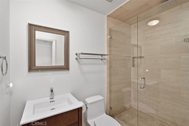 bathroom with walk in shower, vanity, and toilet