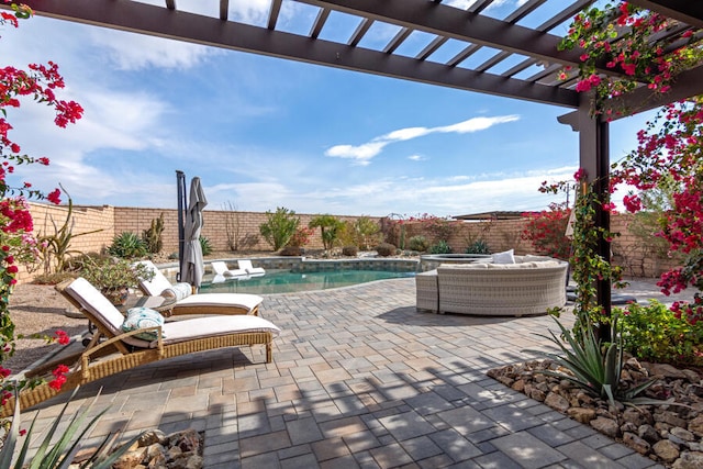 view of patio / terrace with a swimming pool with hot tub and a pergola