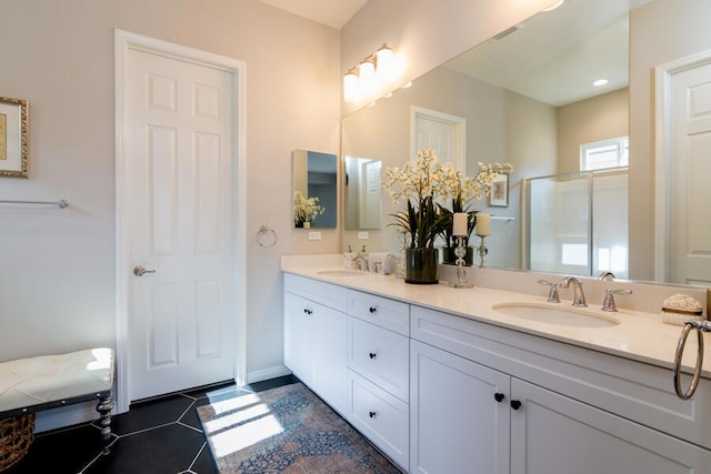 bathroom with tile patterned flooring, vanity, and walk in shower