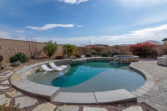 view of pool featuring an in ground hot tub and a patio area