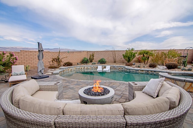 view of swimming pool with a patio area and a fire pit