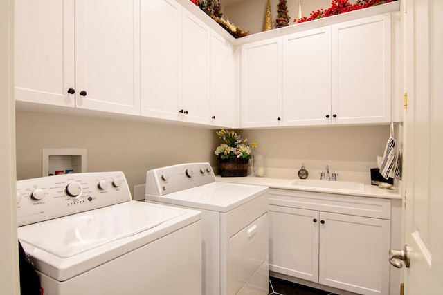 washroom featuring cabinets, separate washer and dryer, and sink