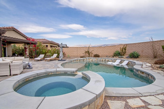 view of pool featuring an outdoor living space, a patio area, and an in ground hot tub